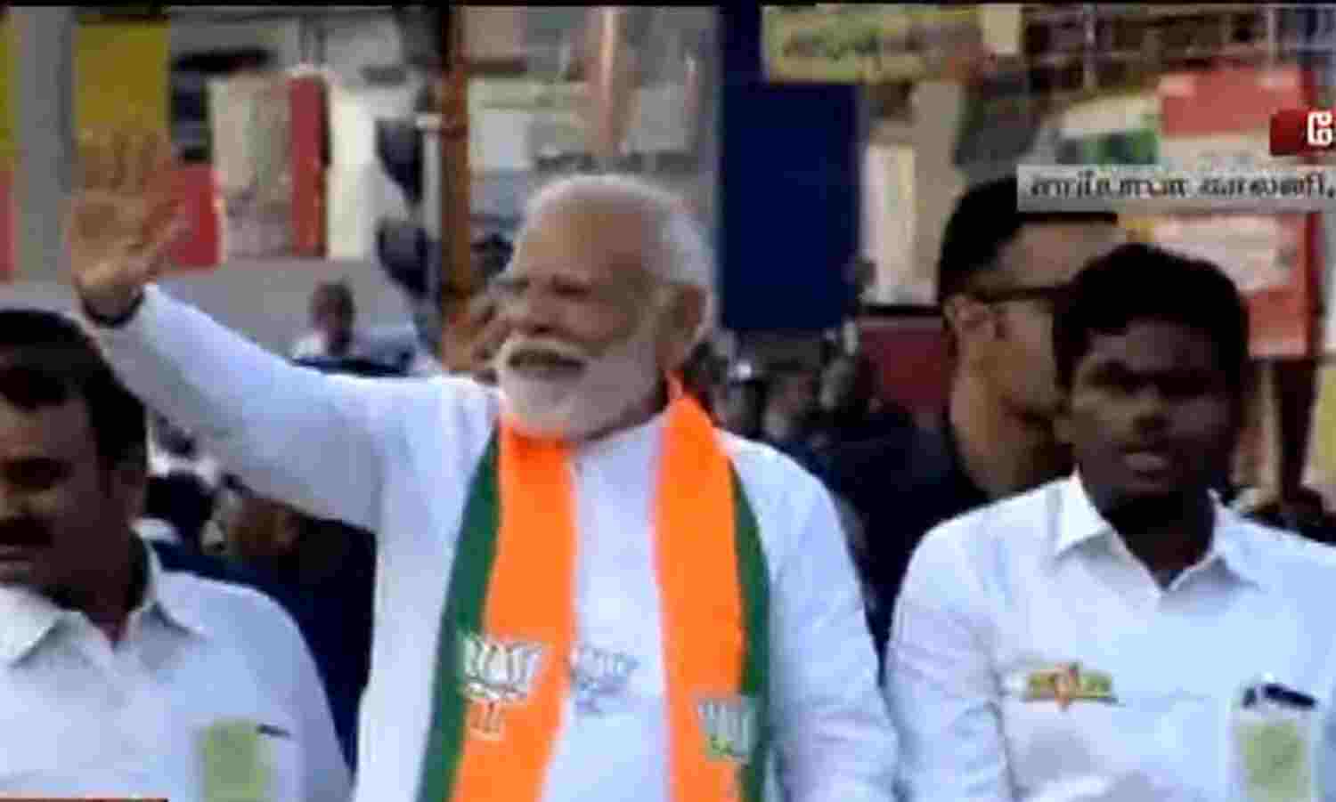 PM Modi is accompanied by TN BJP Chief K.... ... PM Roadshow in Coimbatore live: BJP party-men chant slogans hailing Modi